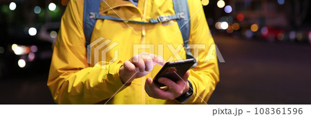 Man uses navigation on smartphone to find way to station 108361596