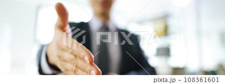 Office worker in business suit extends hand for handshake 108361601