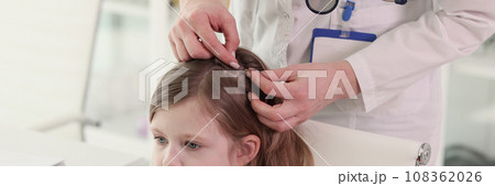 Therapist looks for insects in hair of little patient Therapist looks for insects in hair of little patient 108362026