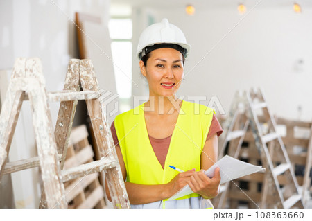 Woman construction worker with project documentation 108363660