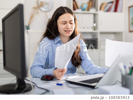 Tired businesswoman working with documents in office at table 108363913