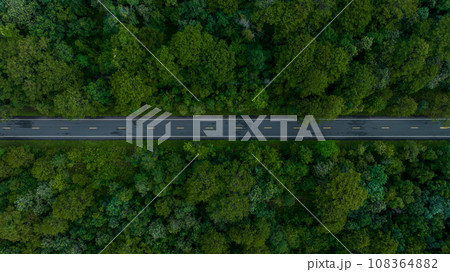 Aerial view over forest road with asphalt road and forest, Road in the middle of the forest up to mountain, Countryside road passing through the green forrest and mountain. Aerial view over forest road with asphalt road and forest, Road in the middle of the forest up to mountain, Countryside road passing through the green forrest and mountain. 108364882