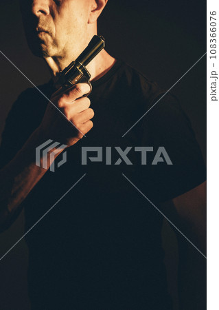 Gunman killer holding pistol artistic photo 108366076
