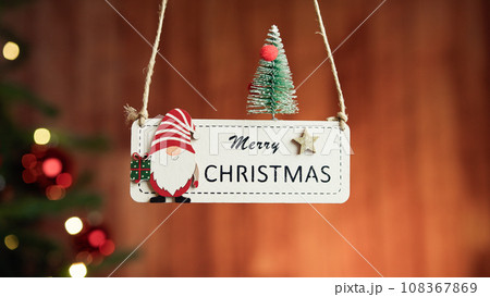 Merry Christmas patch with blurred tree in the background Merry Christmas patch with blurred tree in the background 108367869