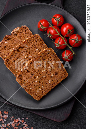 Delicious fresh crispy brown bread with seeds and grains 108372982