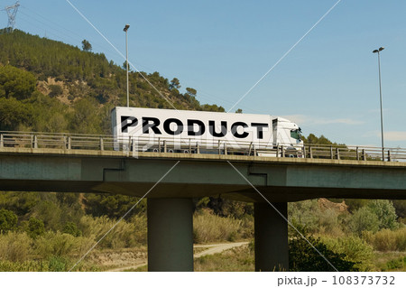 A truck is driving across the bridge, with the inscription on the trailer - Product. A truck is driving across the bridge, with the inscription on the trailer - Product. 108373732