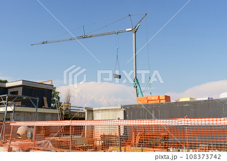 Crane tower on a residential building construction site. 108373742