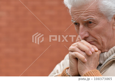 Portrait of an old man having a headache  108373865