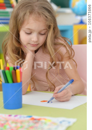 Portrait of cute girl drawing picture at home 108373866