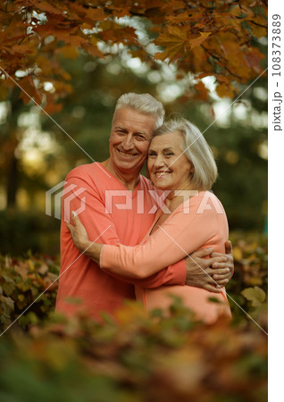 Elderly couple dance in the park in autumn. 108373889