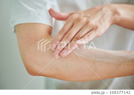 腕にクリームを塗る若い男性 108377142