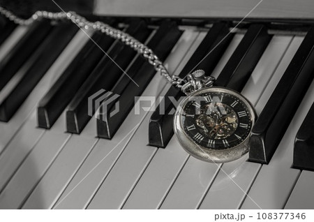 Antique pocket watch on piano keyboard. Time for music conceptual. Antique pocket watch on piano keyboard. Time for music conceptual. 108377346