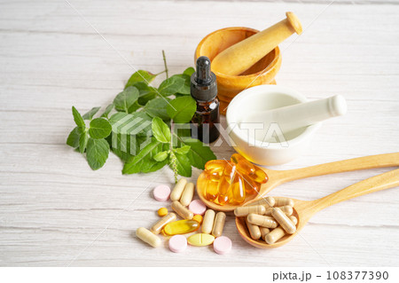 Alternative medicine herbal organic capsule with vitamin E omega 3 fish oil, mineral, drug with herbs leaf natural supplements for healthy good life. Alternative medicine herbal organic capsule with vitamin E omega 3 fish oil, mineral, drug with herbs leaf natural supplements for healthy good life. 108377390