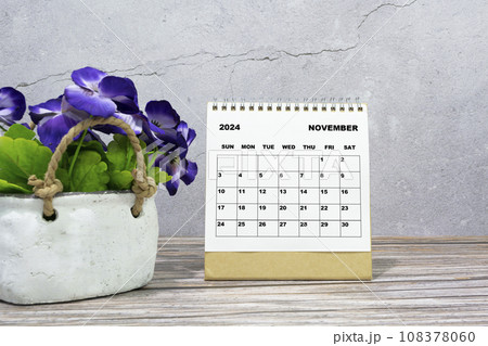 White calendar on office wooden desk with potted plant. 2024 New Year Concept 108378060