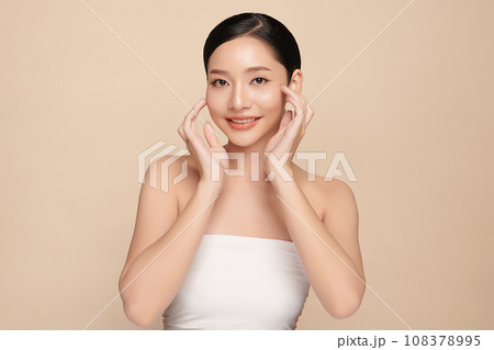 Beautiful young asian woman with clean fresh skin on beige background, Face care, Facial treatment, Cosmetology, beauty and spa, Asian women portrait. Beautiful young asian woman with clean fresh skin on beige background, Face care, Facial treatment, Cosmetology, beauty and spa, Asian women portrait. 108378995