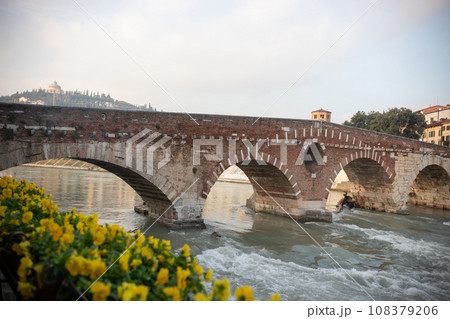 An arched bridge over flowing water - italian medieval landscape An arched bridge over flowing water - italian medieval landscape 108379206