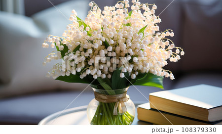 bouquet of lilies of the valley in vase on table by sofa, and interior design details, natural light bouquet of lilies of the valley in vase on table by sofa, and interior design details, natural light 108379330