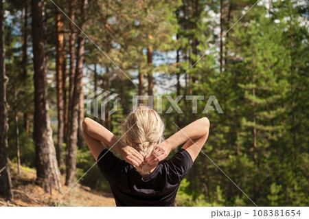Beautiful woman against the background of a pine forest, forest baths, the idea of restoring health Beautiful woman against the background of a pine forest, forest baths, the idea of restoring health 108381654