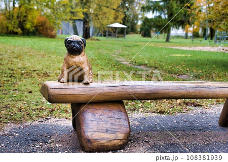 Valga, Estonia - October 22, 2023: Public bus waiting stops. Wooden sculptures as benches. Valga, Estonia - October 22, 2023: Public bus waiting stops. Wooden sculptures as benches. 108381939
