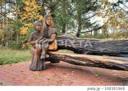 Valga, Estonia - October 22, 2023: Public bus waiting stops. Wooden sculptures as benches. Valga, Estonia - October 22, 2023: Public bus waiting stops. Wooden sculptures as benches. 108381968