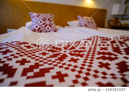 Recreation area in the hotel. Bed linen with red national symbols of Estonia 108382087