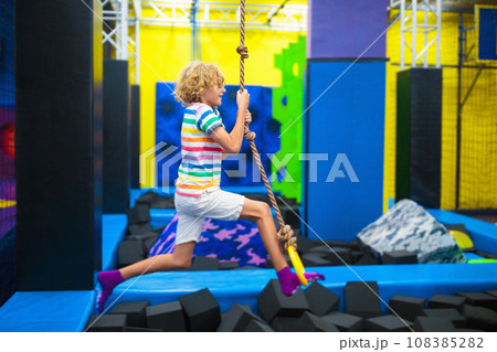 Child jumping in trampoline park. Bounce fun. Child jumping in trampoline park. Bounce fun. 108385282