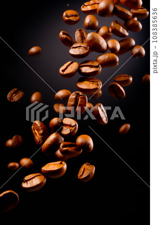 Coffee beans are shown in motion on black background, in the style of dynamic poses. Coffee beans are shown in motion on black background, in the style of dynamic poses. 108385636