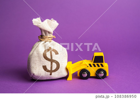 A bulldozer pushes a dollar money bag. Ineffective use of funds. Financing of dismantling works. Demolition services, land leveling. Industry machinery for rent. Money down the drain. 108386950
