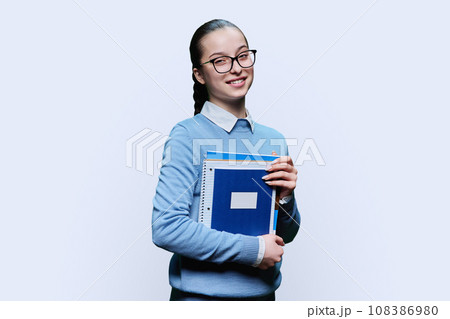 Portrait of teenager girl high school student on white background 108386980