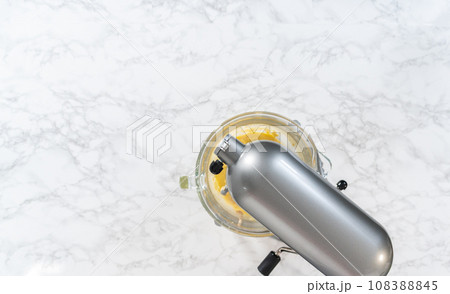 Mixing ingredients in kitchen mixer to bake mini Easter bread kulich. Mixing ingredients in kitchen mixer to bake mini Easter bread kulich. 108388845