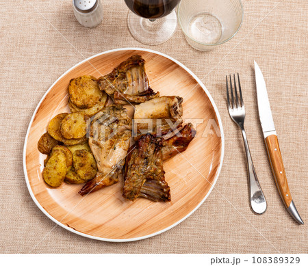 Baked rabbit with potatoes 108389329