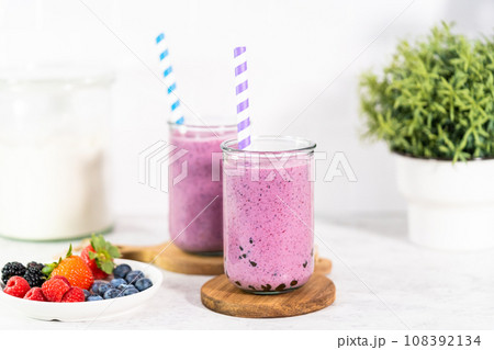 Freshly made mixed berry boba smoothie in a drinking jar with paper straw. 108392134