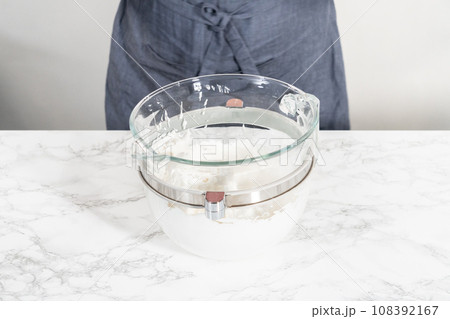 Mixing ingredients in kitchen electric mixer to bake meringue cookies. Mixing ingredients in kitchen electric mixer to bake meringue cookies. 108392167