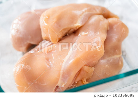 Shredded chicken in a pressure cooker. Measured ingredients in glass mixing bowls to shredded chicken. Shredded chicken in a pressure cooker. Measured ingredients in glass mixing bowls to shredded chicken. 108396098