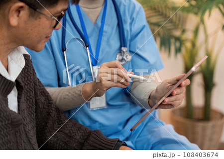 Asian nurse showing health checkup report to older and giving advice. Home nursing and healthcare caregiver concept 108403674