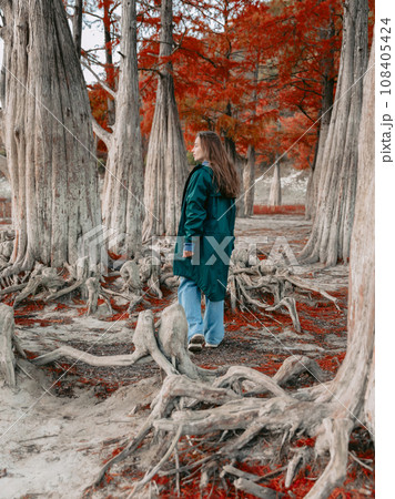Attractive woman in a jacket in autumnal park. Portrait of people in park in autumn. 108405424