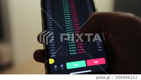 Man analyst using mobile phone app and computer. Analytics for cryptocurrency financial stock market. Trader at the stock exchange. Man analyst using mobile phone app and computer. Analytics for cryptocurrency financial stock market. Trader at the stock exchange. 108406222