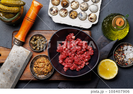 Cooking savory beef tartare and brown bread toasts Cooking savory beef tartare and brown bread toasts 108407906