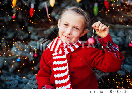 Christmas children elf ears. Child waiting for Christmas in wood. portrait of little girl decorating christmas tree. winter holidays and people concept. Happy Holidays. Christmas children elf ears. Child waiting for Christmas in wood. portrait of little girl decorating christmas tree. winter holidays and people concept. Happy Holidays. 108408330