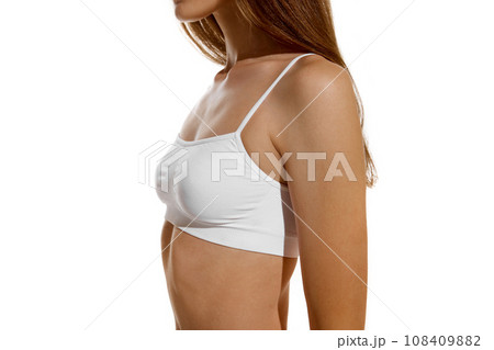 Side view. Cropped perfect naked body shape female body, breast dressed in innerwear against studio background. Concept of dieting. 108409882