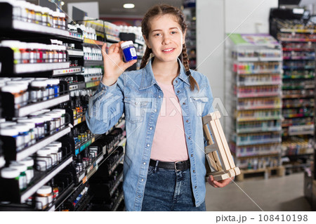Girl shopping color in glass jar in art store Girl shopping color in glass jar in art store 108410198