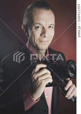 Photographer videographer in studio in suit Photographer videographer in studio in suit 108411304