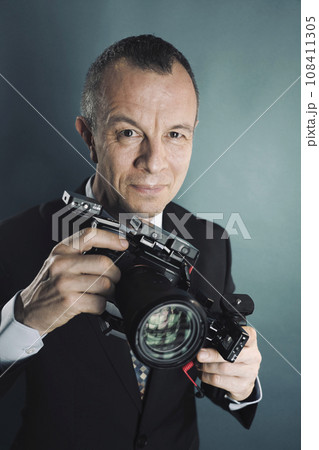 Photographer videographer in studio in suit Photographer videographer in studio in suit 108411305