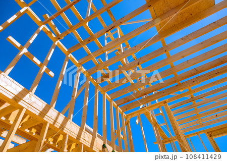 New house roof construction using wooden frame trusses support beams New house roof construction using wooden frame trusses support beams 108411429