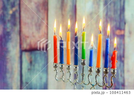 Lighting hanukkiah Jewish menorah candles ablaze at Hanukkah festival Lighting hanukkiah Jewish menorah candles ablaze at Hanukkah festival 108411463