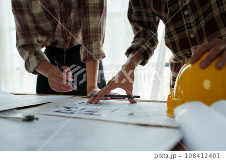 Engineers, designers and interior designers are finalizing the design of interiors by discussing selecting materials and colors to design rooms to present to clients 108412401