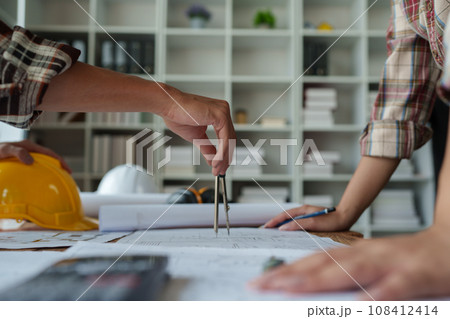 Engineers, designers and interior designers are finalizing the design of interiors by discussing selecting materials and colors to design rooms to present to clients 108412414