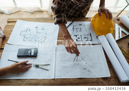 Engineers, designers and interior designers are finalizing the design of interiors by discussing selecting materials and colors to design rooms to present to clients 108412416