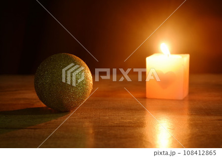 golden ball couple candle light for decoration in Christmas and new year festival in black background 108412865