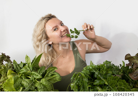 Young woman with a set of green Ingredients lettuce, spinach for a healthy diet Young woman with a set of green Ingredients lettuce, spinach for a healthy diet 108420345
